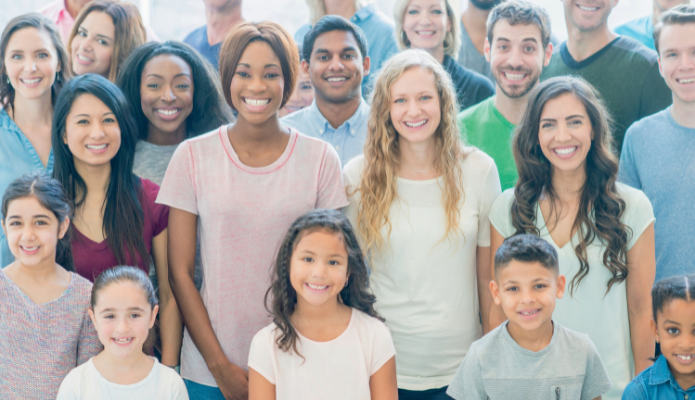 Diverse group of adults and children smiling
