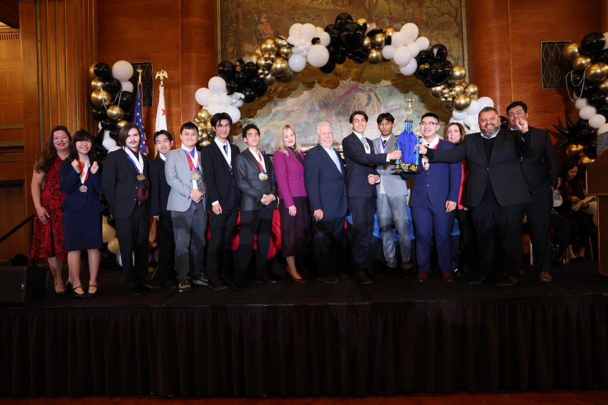 Alhambra High School Academic Decathlon Team on stage holding first place trophy