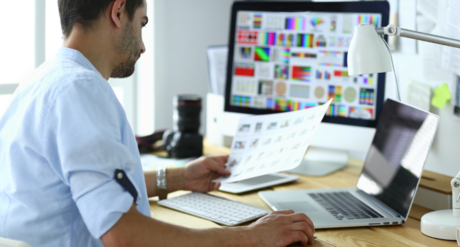 person using laptop looking at color accuracy documents for accessibility