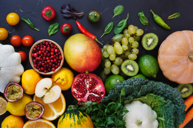 various fruits and vegetables spread out on table