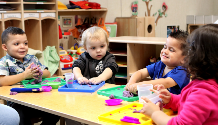 Preschool children playing with clay