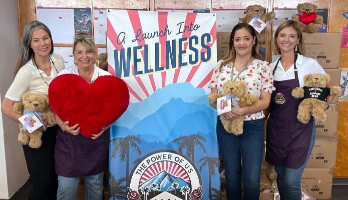 LACOE employees holding comfort bears