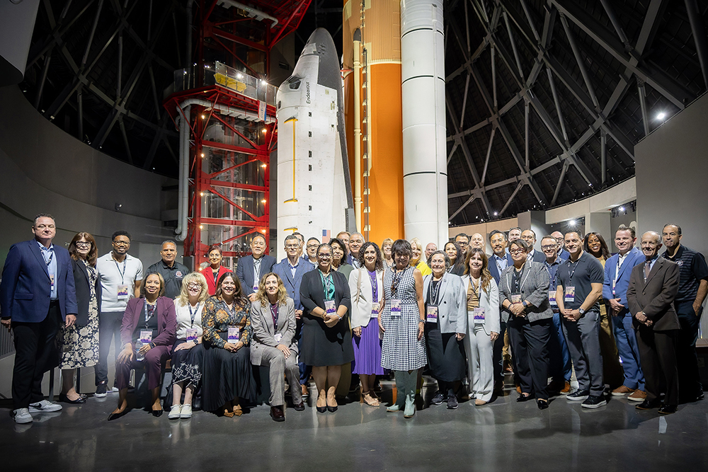 Superintendents take a picture next to the Space Shuttle Endeavor