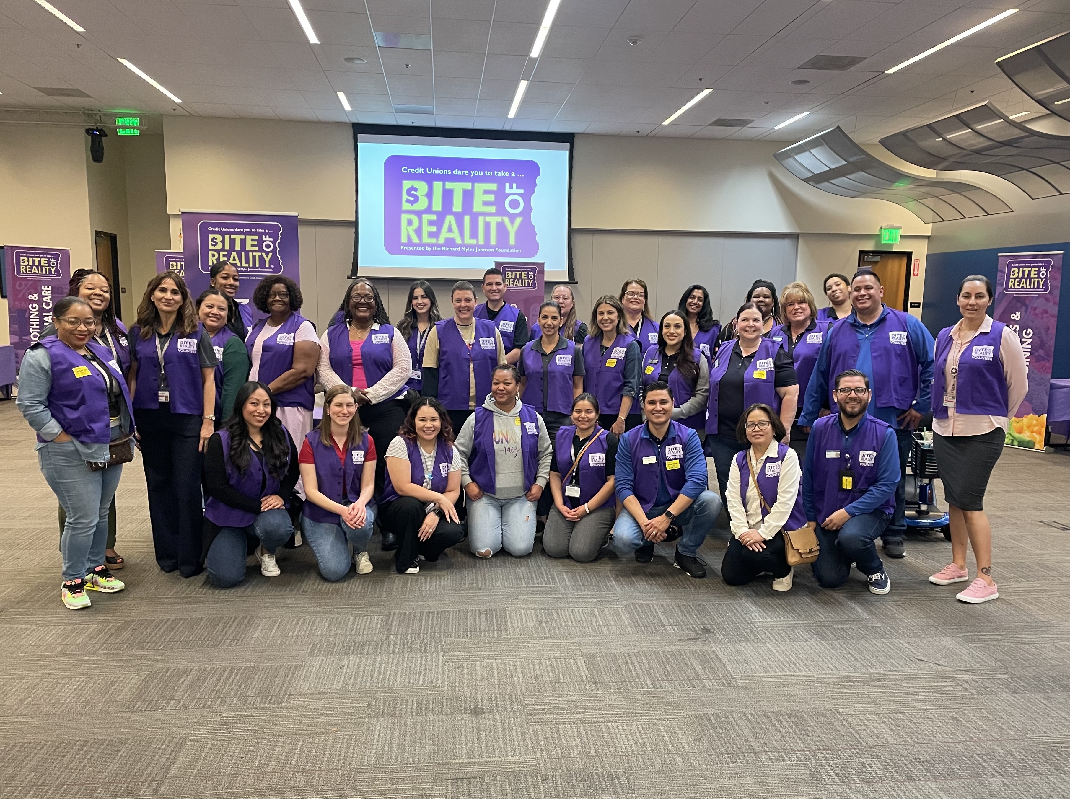 Group of people posing for a photo during "Bite of Reality" event