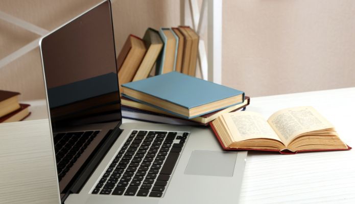 Books and a laptop on a desk