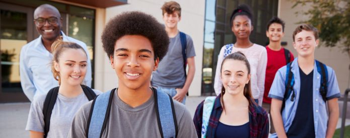 Students and teacher standing outside