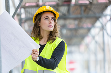 Construction woman looking up