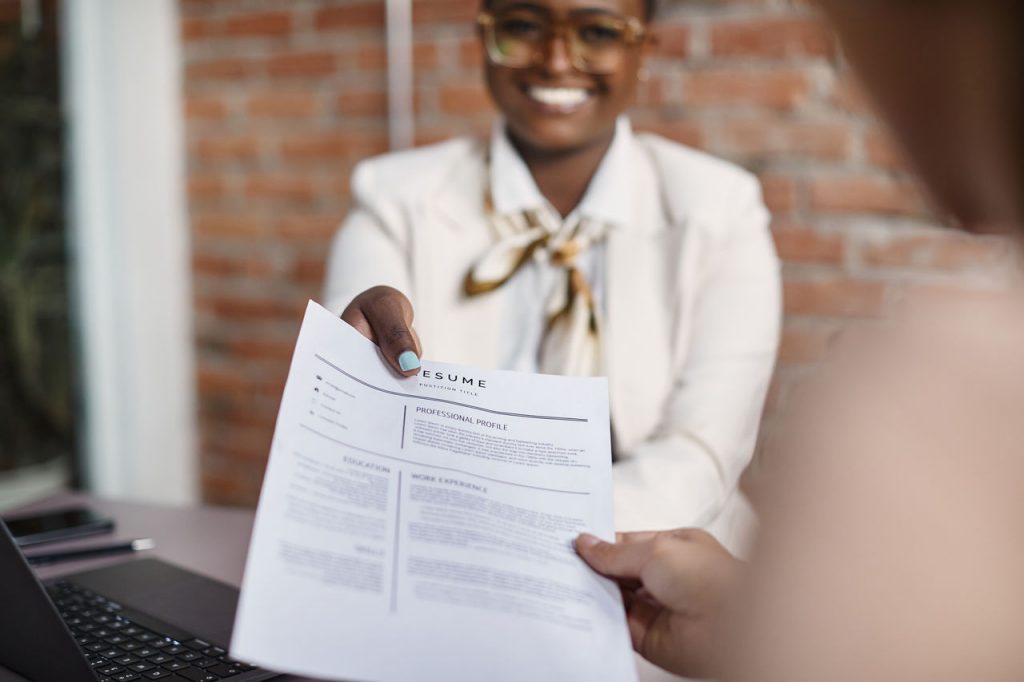 Businesswoman gives her resume during job interview in the office.