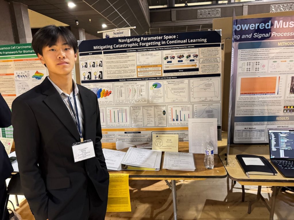 Student in front of science fair project