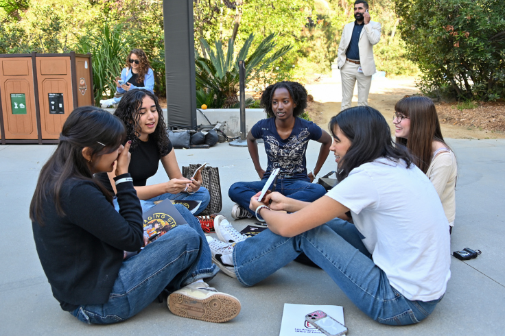 Girls sitting in a circle on the floor at the Engaging Girls in STEM event