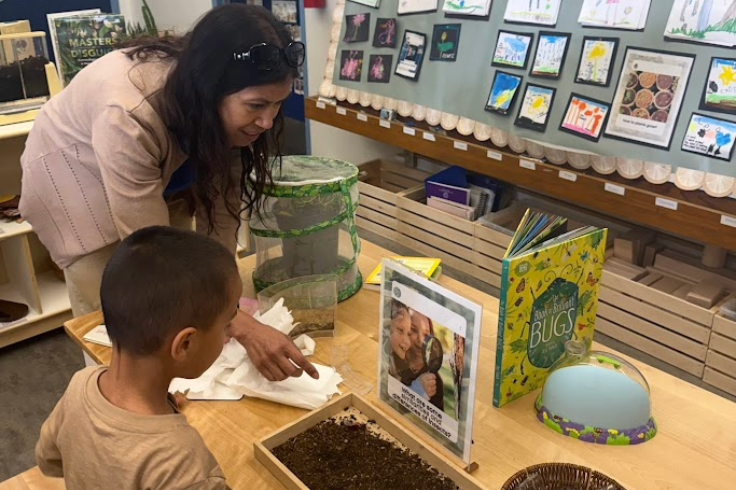 Teacher helping a student in a TK classroom