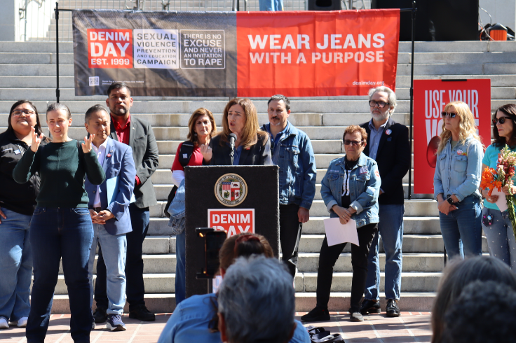 Dr. Duardo speaking at podium with people behind her