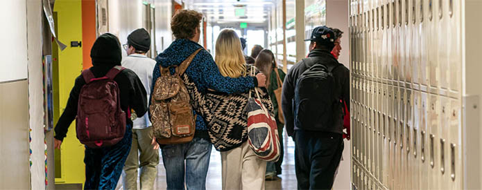 students walking through school hallway