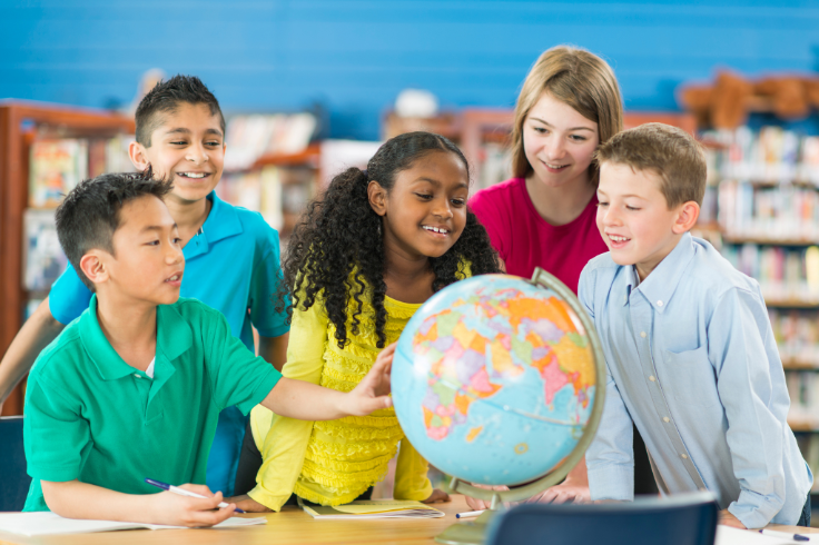 Student looking at globe