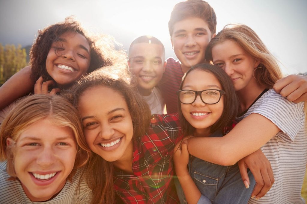 Groups of students posing on a sunny day