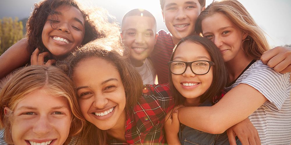 Groups of students posing on a sunny day