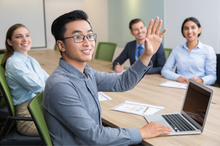 Man raising hand in group meeting
