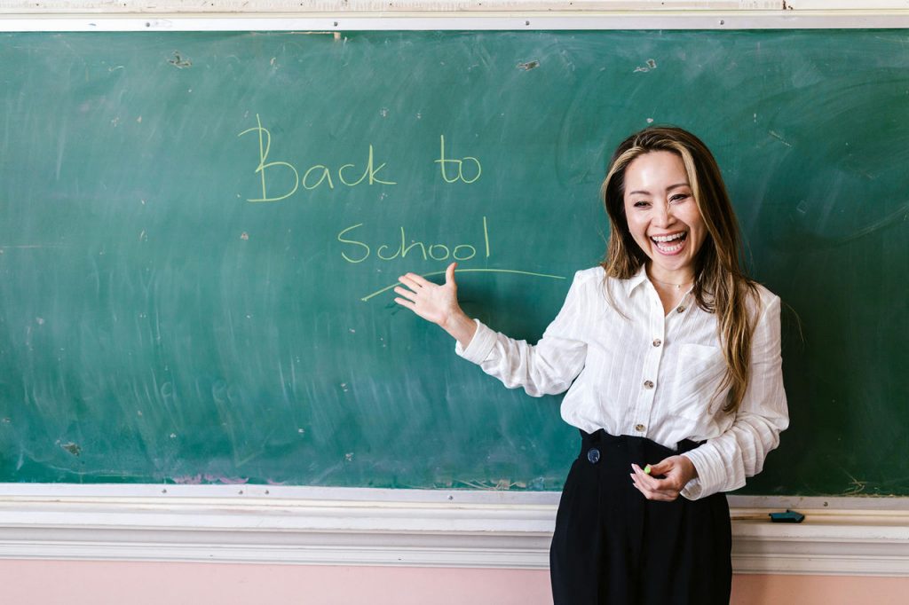 Teacher standing in front of the chalk board