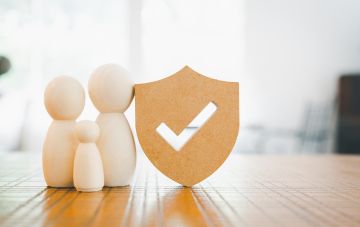 family of 3 figurines and security check symbol