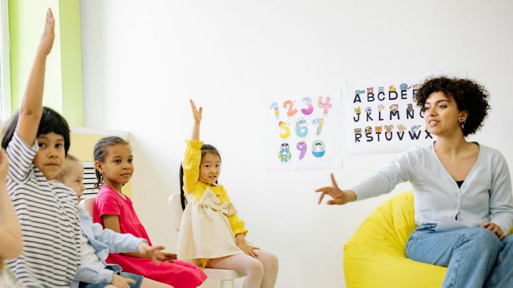 Photo of young students in class with teacher