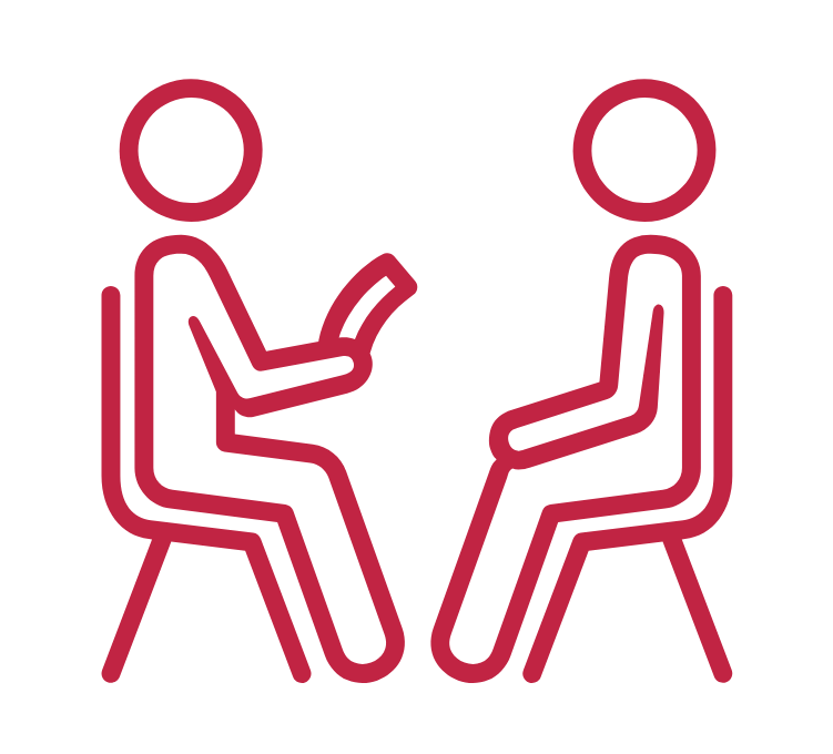 Two people sitting in chairs talking