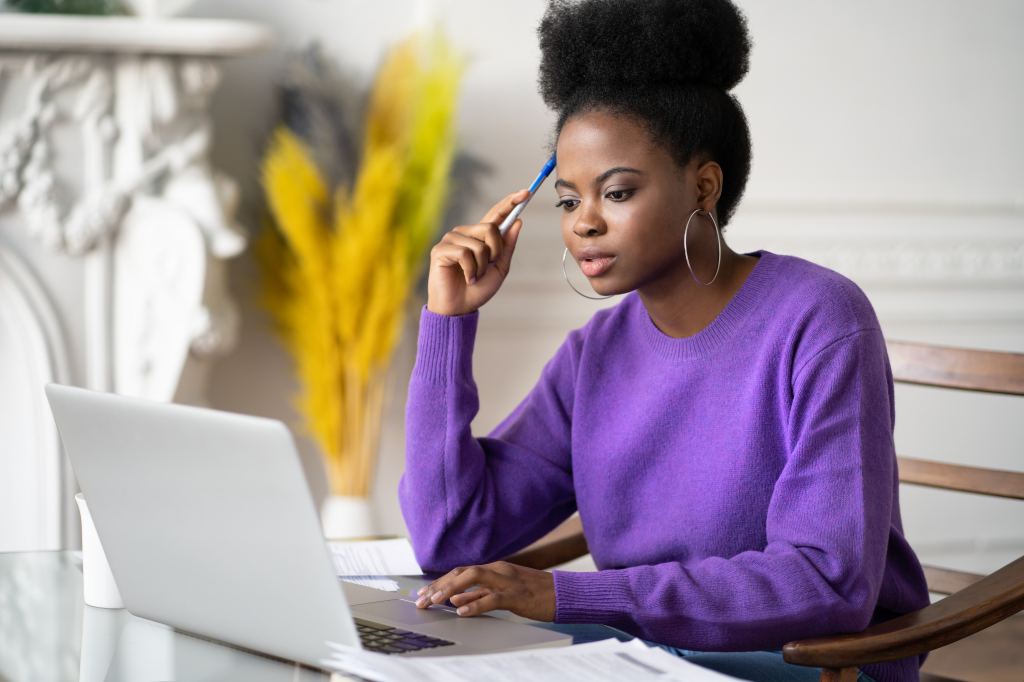 student in purple sweater sitting in front of her laptop